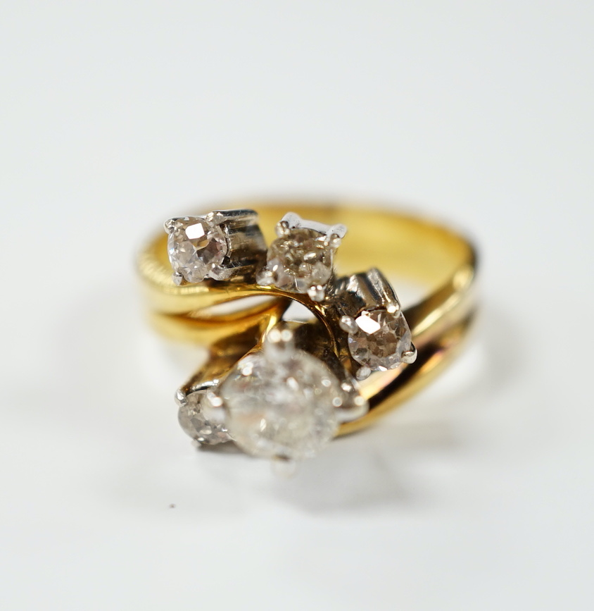 A yellow metal and graduated five stone diamond cluster set dress ring, in a raised setting, size J/K, gross weight 5.5 grams.